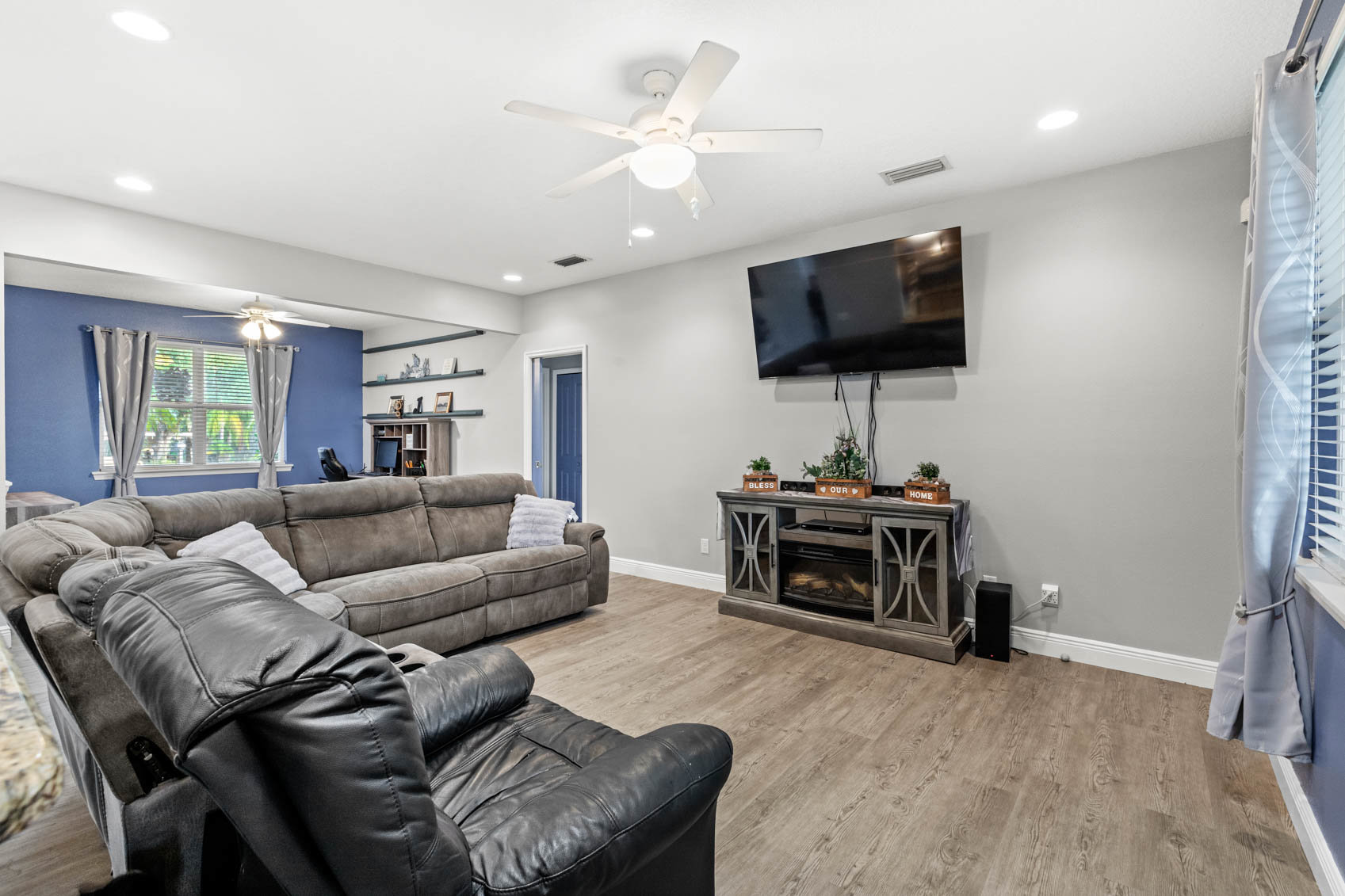 living room with blue walls and grey sectional